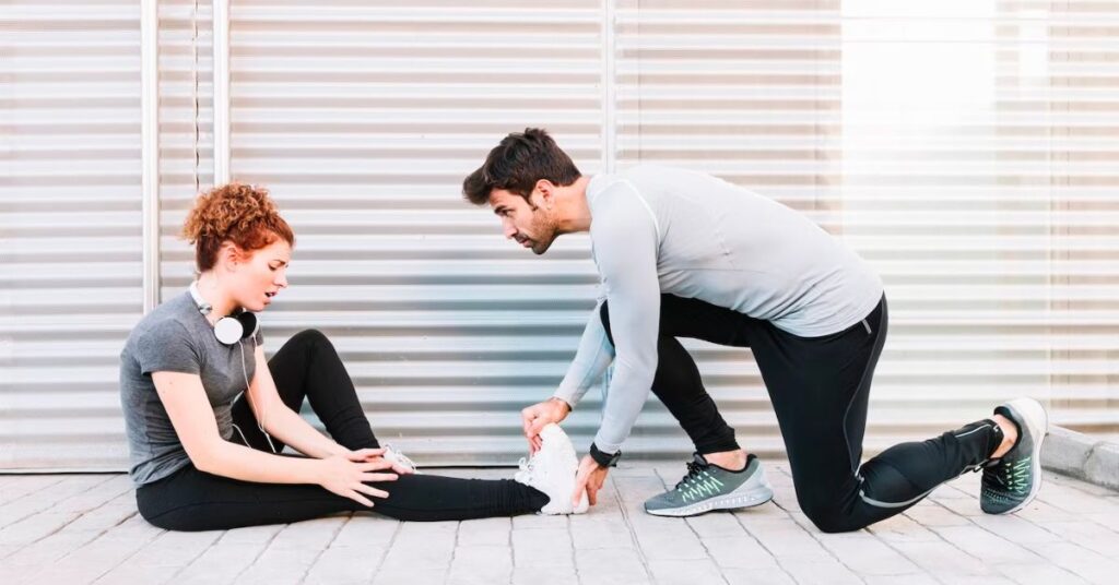 a lady on a floor and a man checking her feet