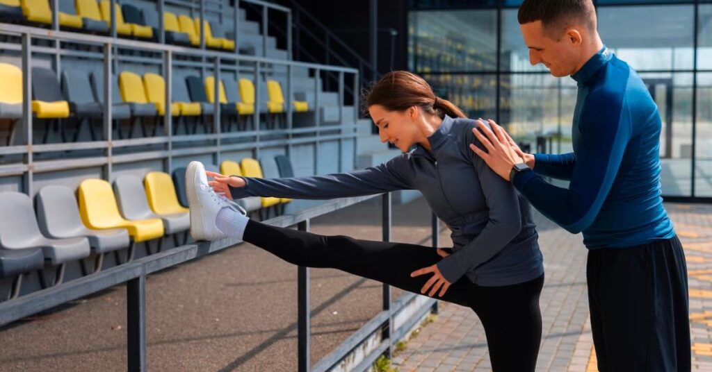 a man helping a lady to do stretching 