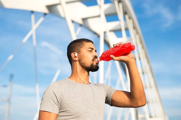 a man hydrating himself by drinking electrolytes