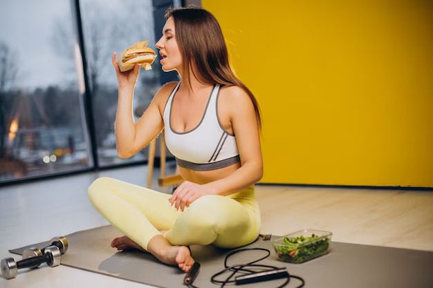 a lady sitting on the floor eating food