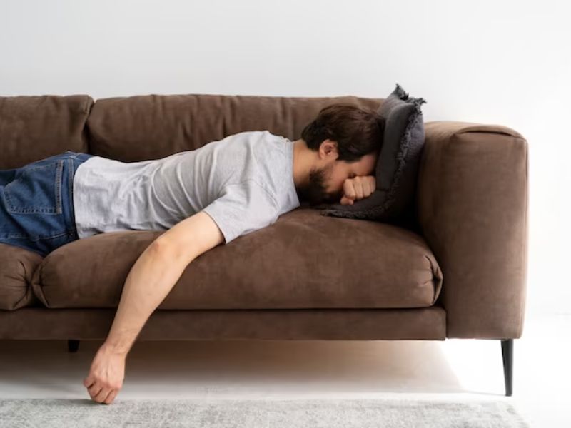 a man slouching in the couch 