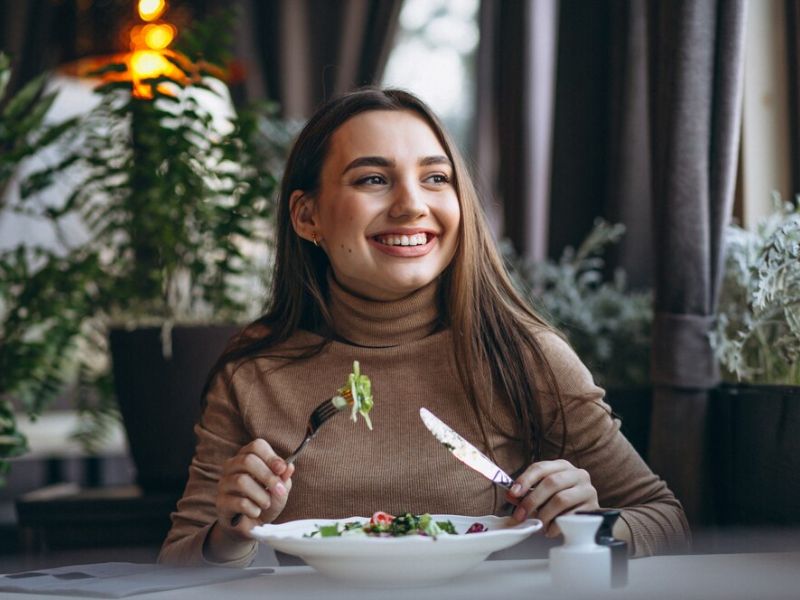 a lady happily eating healthy food
