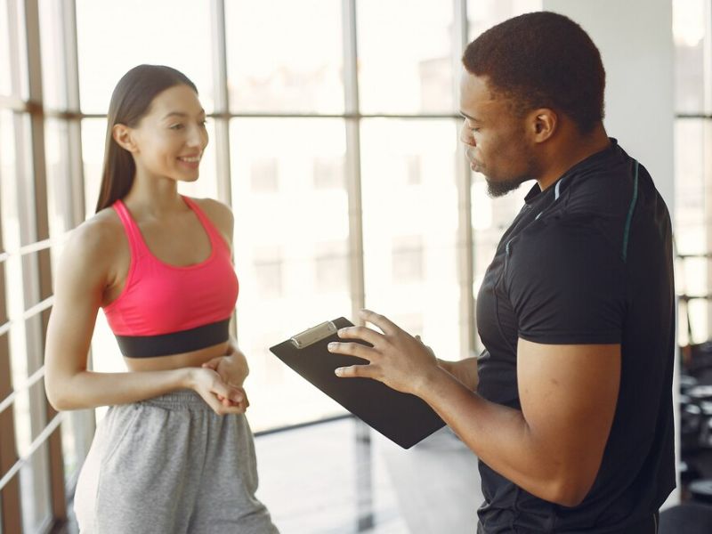 a lady consulting with the personal trainer 